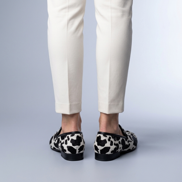 Black Shoes For Women | Slip-On Loafers Cow Print Black and White back view worn